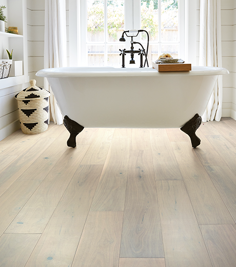 standalone white tub on waterproof flooring